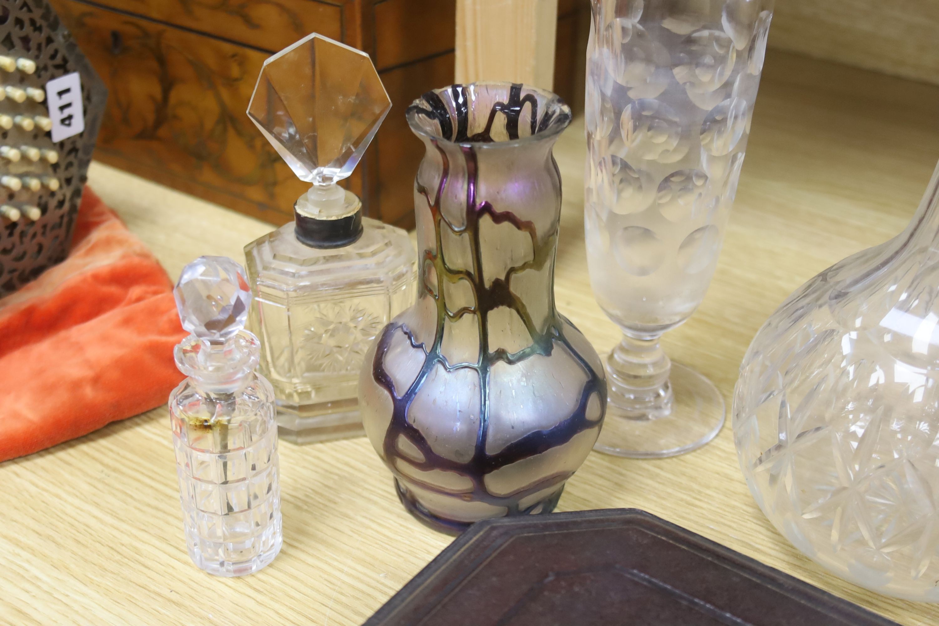 A collection of glass perfume bottles, three decanters, two scent bottles with cut glass stoppers and two handled bowl and an Art Nouveau style vase and plated cruet